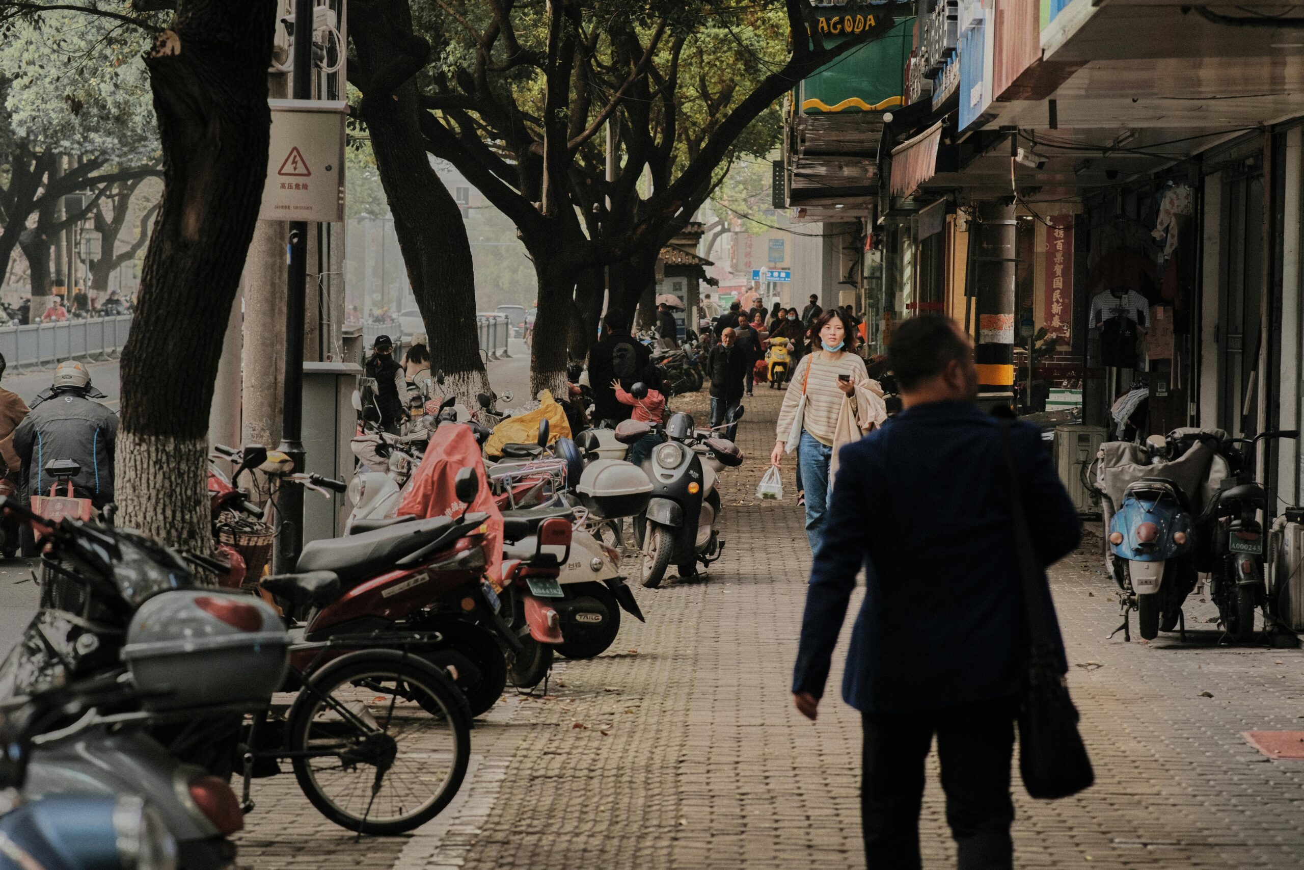 Pedestrians crossing a parking lot as vehicles slow down to yield the pedestrian right of way.