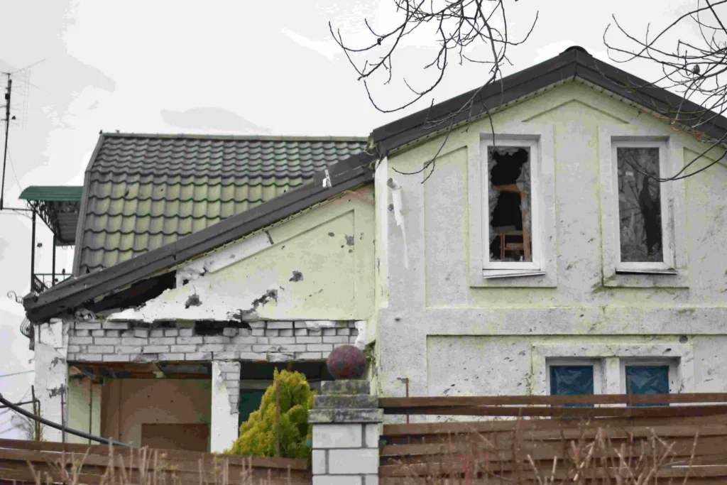 Person reviewing documents while filing a property damage insurance claim after an accident.