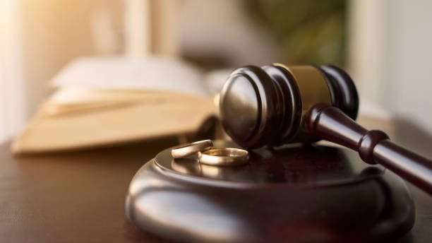 Woman filling out divorce forms to file for divorce in New York without a lawyer